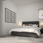 Chambre minimaliste avec un lit et des cadres accrochés au mur